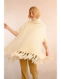 Turtleneck poncho with pompoms