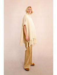 Turtleneck poncho with pompoms